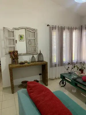 a living room with a red pillow on the floor at Casa Maru in Villa Carlos Paz
