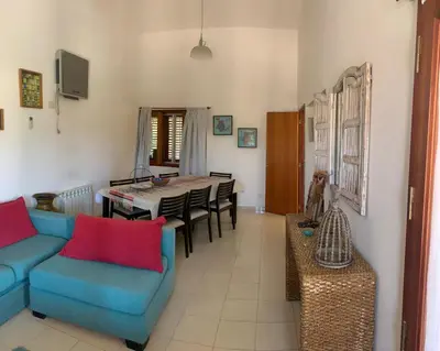 a living room with a blue couch and a table at Casa Maru in Villa Carlos Paz