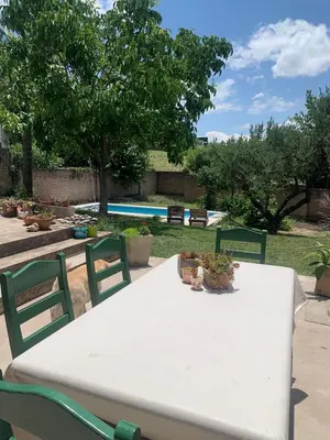 a white table and chairs with plants on it at Casa Maru in Villa Carlos Paz
