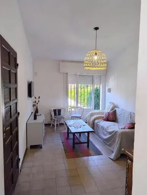 a living room with a couch and a table at Chalet House - Villa Carlos Paz in Villa Carlos Paz