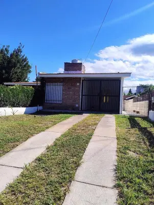 a sidewalk in front of a house with a garage at Chalet House - Villa Carlos Paz in Villa Carlos Paz