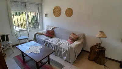 a living room with a couch and a table at Chalet House - Villa Carlos Paz in Villa Carlos Paz