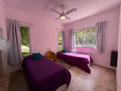 a bedroom with two beds and a ceiling fan at Poseidon in Las Chacras (La Paz)
