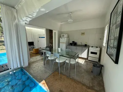 a kitchen with a dining table and a kitchen with a pool at Poseidon in Las Chacras (La Paz)