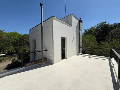 a small white building with a door on a roof at Poseidon in Las Chacras (La Paz)