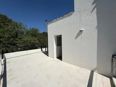 a white building with a door on the side of it at Poseidon in Las Chacras (La Paz)