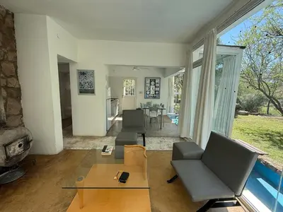 a living room with a couch and chairs and a table at Poseidon in Las Chacras (La Paz)