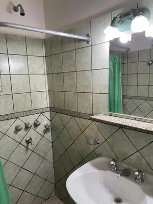 a bathroom with a sink and a mirror at Are-Kepay in Villa Carlos Paz