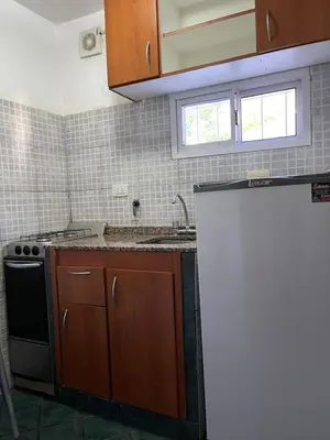 a kitchen with a stove and a sink and a refrigerator at Are-Kepay in Villa Carlos Paz