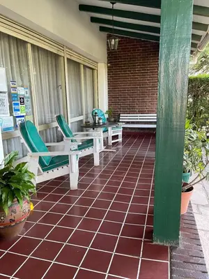 a patio with two chairs and a table and a table and chairs at Are-Kepay in Villa Carlos Paz