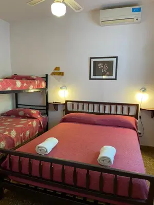 a bedroom with two bunk beds with towels on the bed at Are-Kepay in Villa Carlos Paz