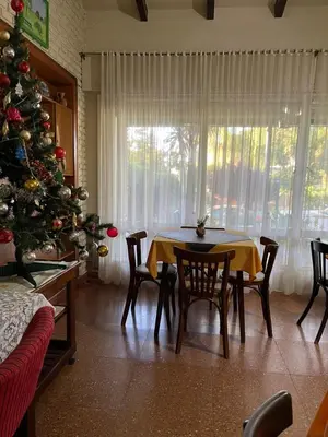 a dining room with a christmas tree and a table and chairs at Are-Kepay in Villa Carlos Paz