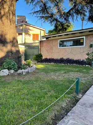 a house with a tree in the yard at Are-Kepay in Villa Carlos Paz