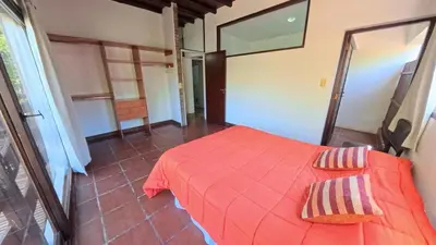 a bedroom with a red bed in a room at Demeter in Las Chacras (La Paz)