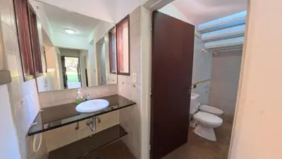 a bathroom with a sink and a toilet and a mirror at Demeter in Las Chacras (La Paz)
