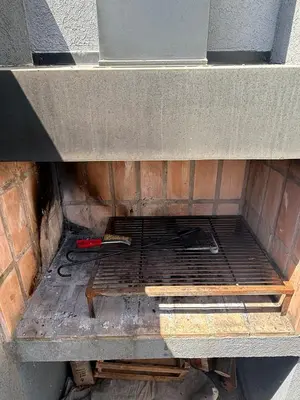 an inside of an oven with tools on a shelf at Triplex Premium in Villa Carlos Paz