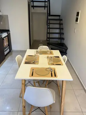 a table with wine glasses on it in a room at Triplex Premium in Villa Carlos Paz