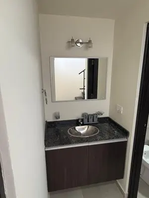 a bathroom with a sink and a mirror at Triplex Premium in Villa Carlos Paz