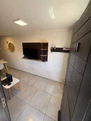 a living room with a flat screen tv on the wall at Triplex Premium in Villa Carlos Paz