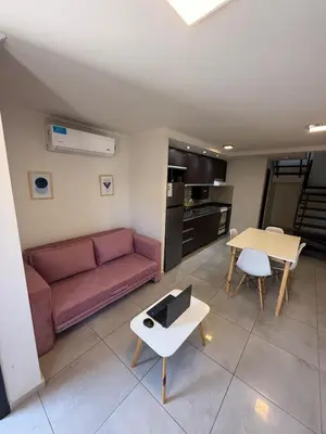 a living room with a couch and a table at Triplex Premium in Villa Carlos Paz