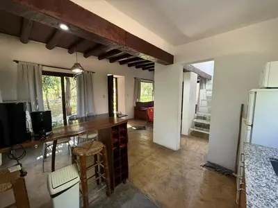 a kitchen with a table and a refrigerator in a room at Atlas in Las Chacras (La Paz)
