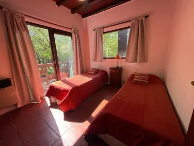 a bedroom with two beds and a window at Atlas in Las Chacras (La Paz)
