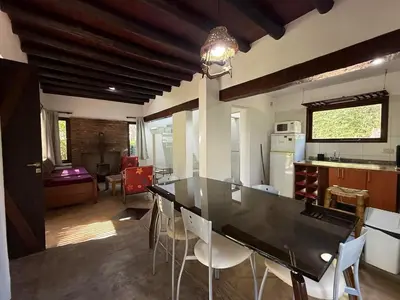 a kitchen and dining room with a table and chairs at Atlas in Las Chacras (La Paz)
