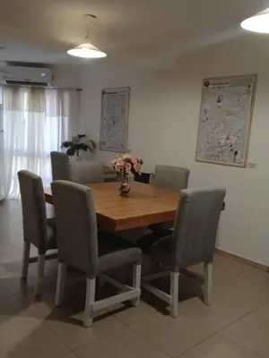 a dining room with a wooden table and chairs at Corazón de nva cba in Cordoba