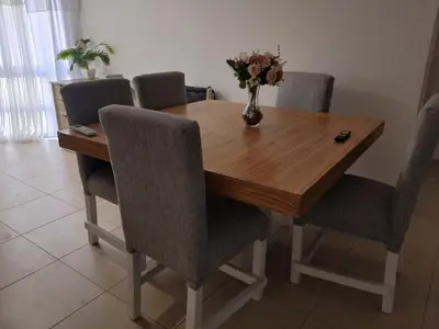 a wooden table with chairs and a vase of flowers on it at Corazón de nva cba in Cordoba
