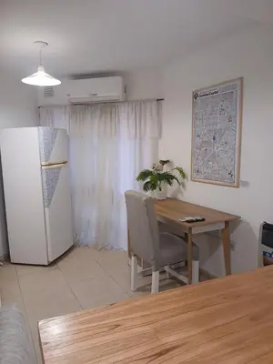 a dining room with a table and a table and chairs at Corazón de nva cba in Cordoba