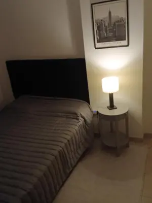 a bedroom with a bed and a lamp on a table at Corazón de nva cba in Cordoba