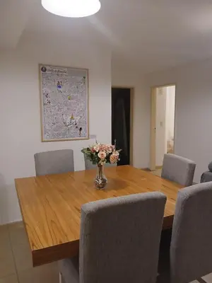a dining room table with chairs and a vase of flowers on it at Corazón de nva cba in Cordoba