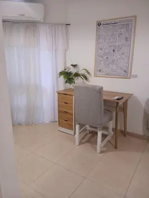 an office with a desk and a chair and a plant at Corazón de nva cba in Cordoba