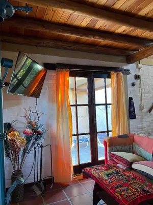 a living room with a couch and a window at Caburé in Mina Clavero