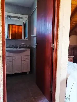 a bathroom with a sink and a mirror at Caburé in Mina Clavero