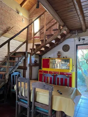 a dining room with a table and some chairs at Caburé in Mina Clavero
