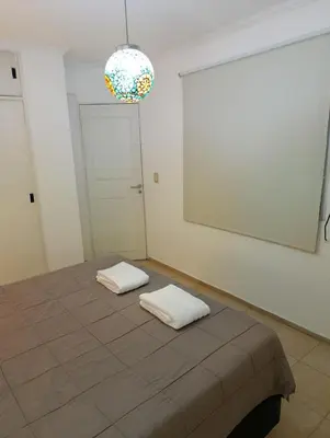 a room with a bed with two white pillows on it at Balcones de Alberdi in Cordoba