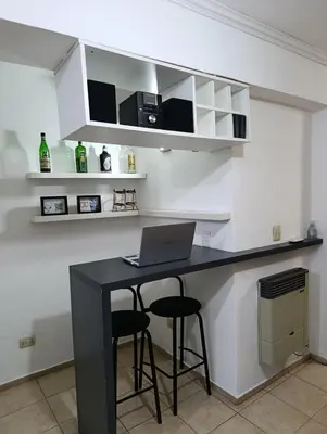 a kitchen with a black counter with a laptop on it at Balcones de Alberdi in Cordoba