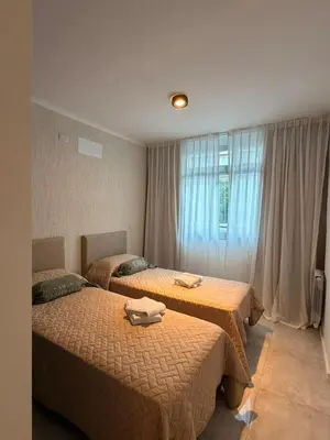 a bedroom with two beds and a window at ALOJATE PREMIUM VILLA CARL0S PAZ - Stefano 2 dor in Villa Carlos Paz