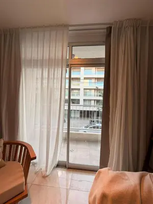 a bedroom with a sliding glass door with a window at ALOJATE PREMIUM VILLA CARL0S PAZ - Stefano 2 dor in Villa Carlos Paz