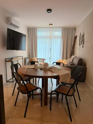 a living room with a table and chairs and a couch at ALOJATE PREMIUM VILLA CARL0S PAZ - Stefano 2 dor in Villa Carlos Paz