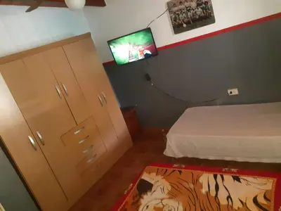a bedroom with a bed and a flat screen tv at casa en bialet masse in San Roque