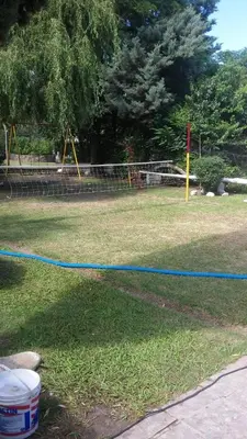 a yard with a playground with a blue hose at casa en bialet masse in San Roque