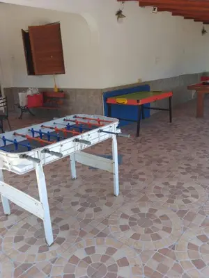 a ping pong table in a room with two tables at casa en bialet masse in San Roque