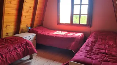 a room with two beds and a window at Cabañas Sacha Huasi in Travesía