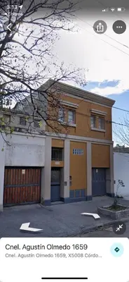 a building with a garage in front of it at Habitación Individual in Cordoba