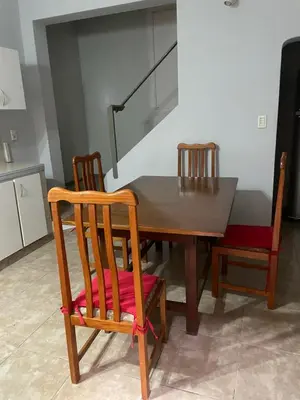 a dining room table with two chairs and a table with a stair at Habitación Individual in Cordoba