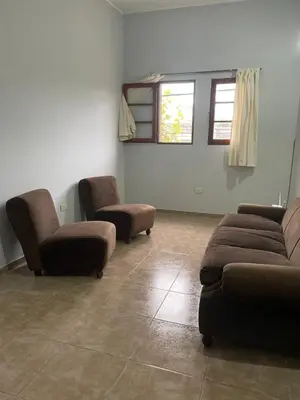 a living room with two couches and two chairs at Habitación Individual in Cordoba