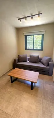 a living room with a couch and a coffee table at Casa Privada Los Cardenales in Nono