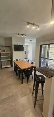 a dining room with a wooden table and chairs at Casa Privada Los Cardenales in Nono